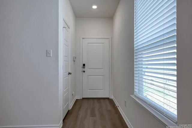 a view of a hallway with a window