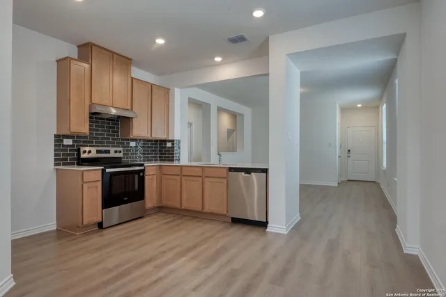 a kitchen with granite countertop a stove and a refrigerator