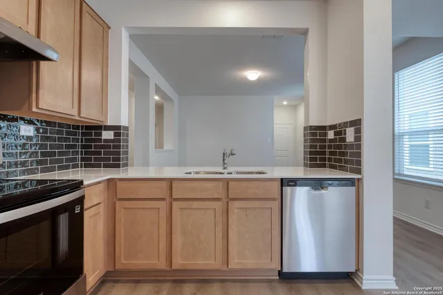 a kitchen with granite countertop a sink and cabinets
