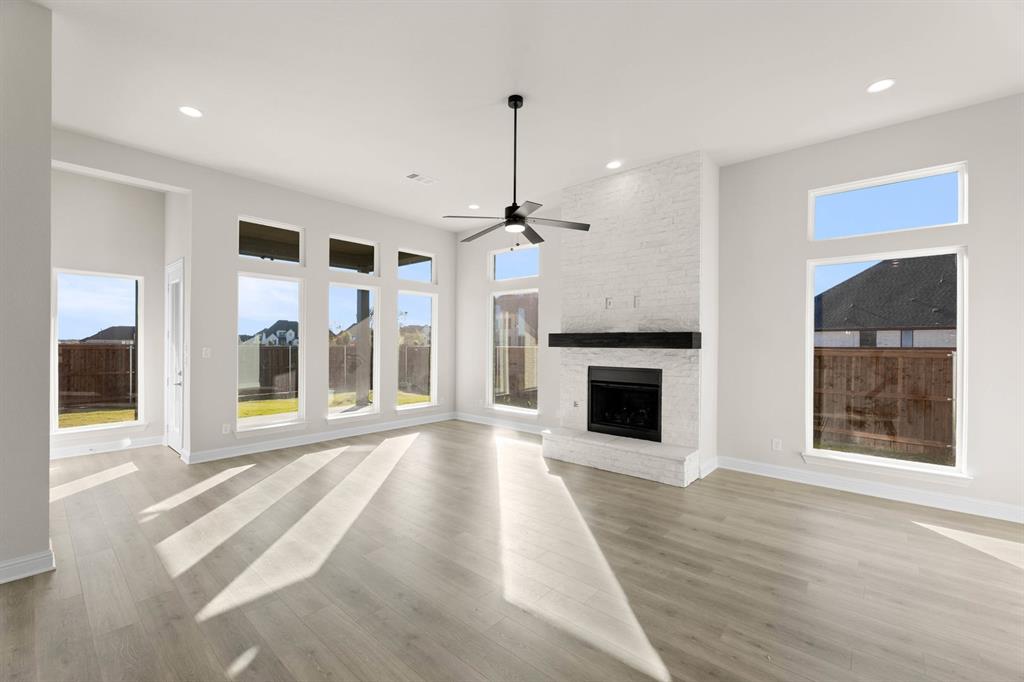 4802 Timberdrift Street Midlothian, TX 76065 - Photo 16 of 34 a view of a livingroom with a fireplace wooden floor and windows