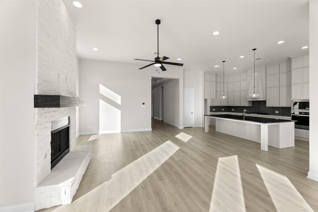 4802 Timberdrift Street Midlothian, TX 76065 - Photo 17 of 34 a kitchen with stainless steel appliances kitchen island granite countertop a stove a sink and a refrigerator