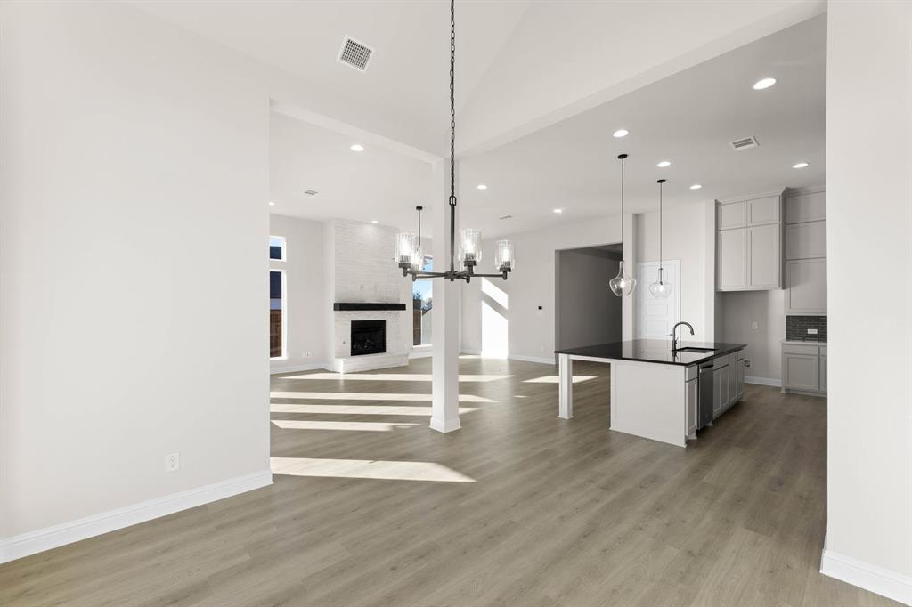 4802 Timberdrift Street Midlothian, TX 76065 - Photo 20 of 34 a view of kitchen with kitchen island white cabinets and stainless steel appliances