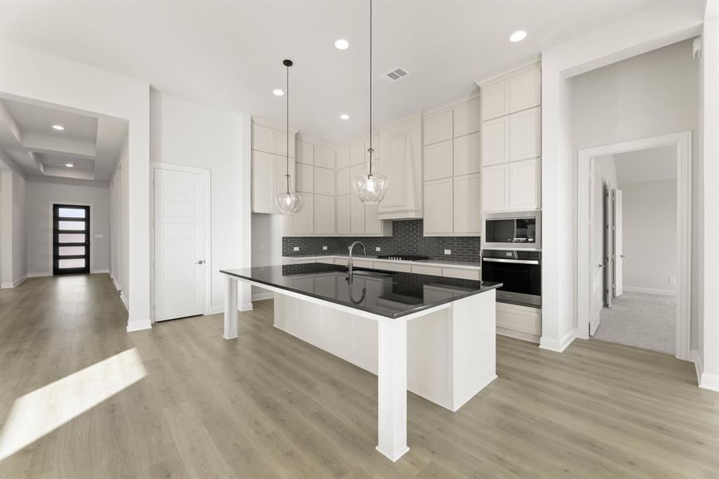 4802 Timberdrift Street Midlothian, TX 76065 - Photo 23 of 34 a kitchen with stainless steel appliances granite countertop a stove a sink and a refrigerator