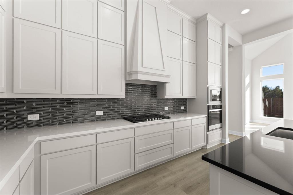4802 Timberdrift Street Midlothian, TX 76065 - Photo 24 of 34 a kitchen with stainless steel appliances granite countertop a sink a stove and white cabinets