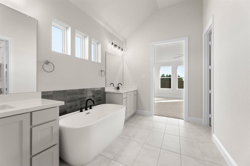 4802 Timberdrift Street Midlothian, TX 76065 - Photo 29 of 34 a bathroom with a tub sink and mirror