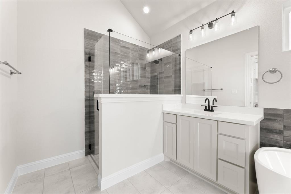 4802 Timberdrift Street Midlothian, TX 76065 - Photo 30 of 34 a bathroom with a shower sink and mirror