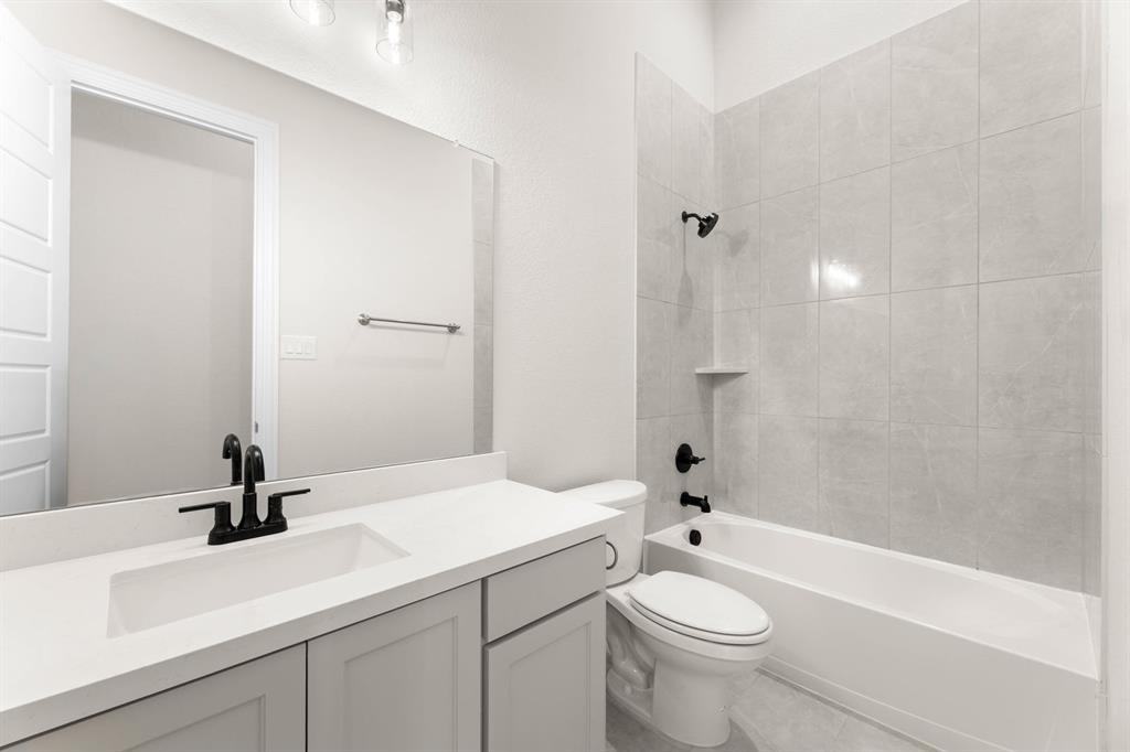 4802 Timberdrift Street Midlothian, TX 76065 - Photo 33 of 34 a bathroom with a sink a toilet and shower