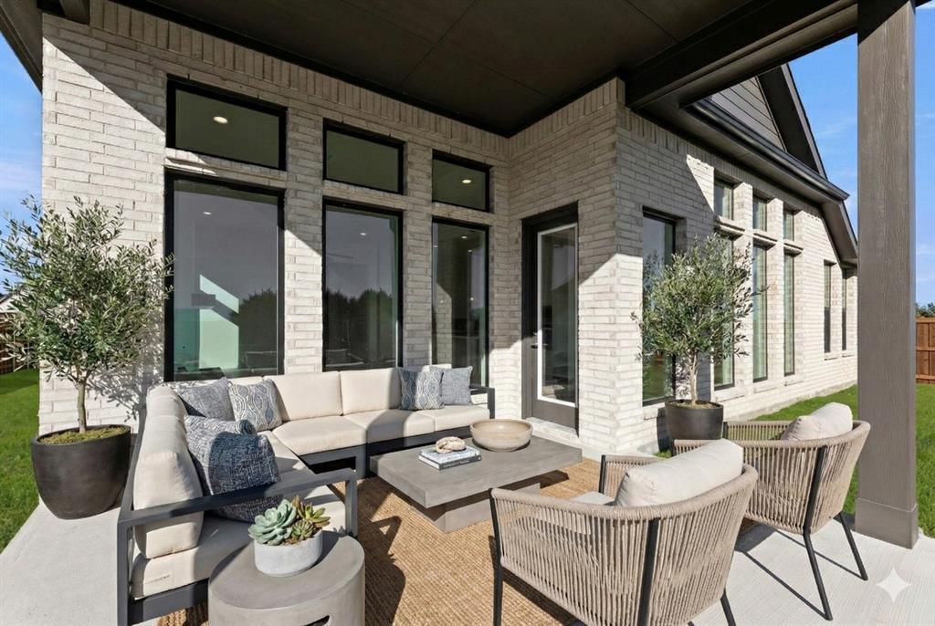 4802 Timberdrift Street Midlothian, TX 76065 - Photo 5 of 34 a view of a patio with table and chairs couches with wooden floor and fence