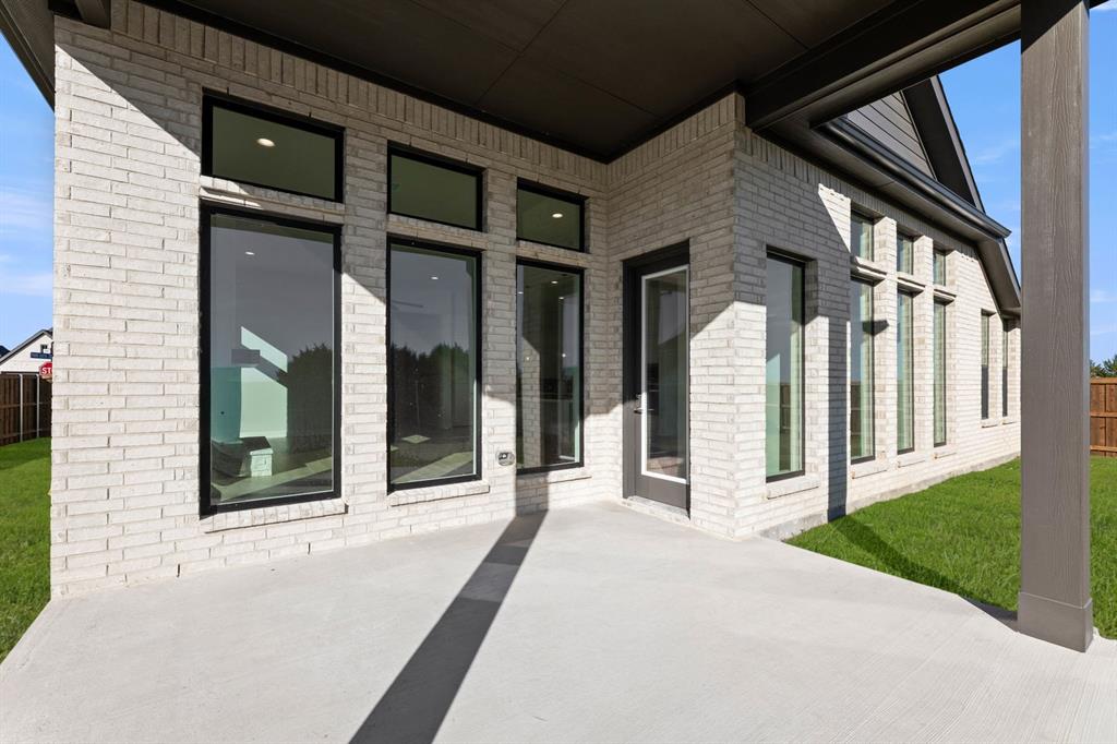 4802 Timberdrift Street Midlothian, TX 76065 - Photo 6 of 34 a view of a brick house with a large windows