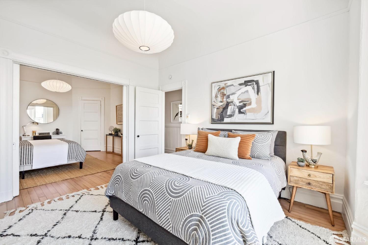 3270 20th Street San Francisco, CA 94110 - Photo 23 of 32 a bedroom with a large bed and a chandelier