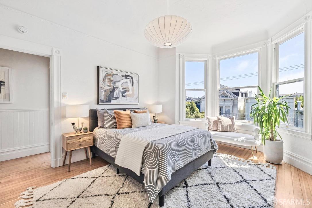 3270 20th Street San Francisco, CA 94110 - Photo 24 of 32 a bedroom with a large bed and a chandelier
