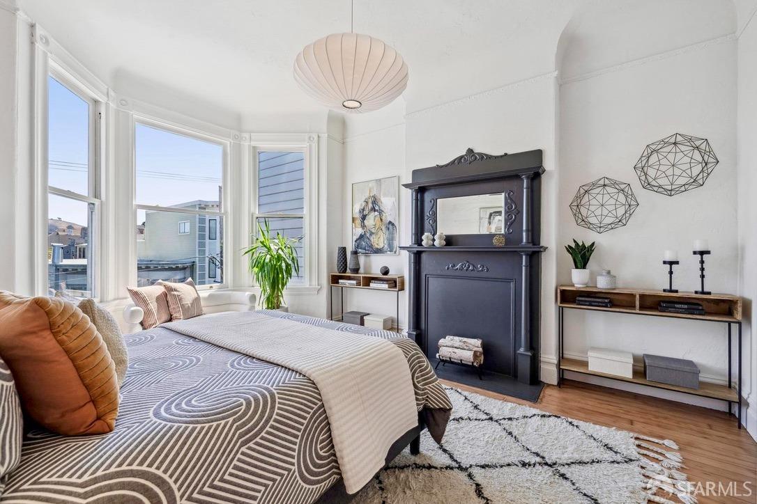 3270 20th Street San Francisco, CA 94110 - Photo 25 of 32 a bedroom with a bed and a chandelier