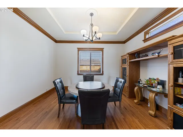 a dining room with furniture window and wooden floor