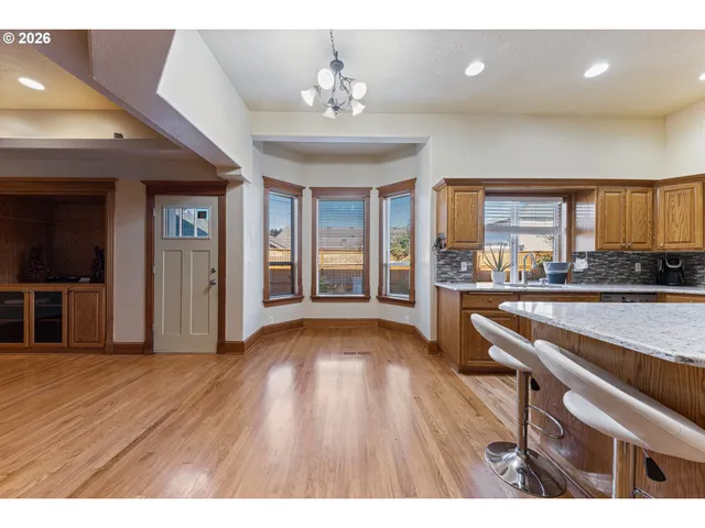 a view of a kitchen with a sink and a large window