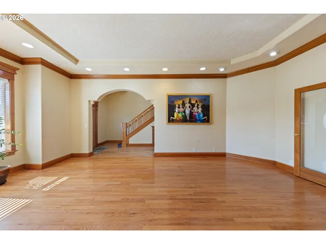 a view of empty room with wooden floor