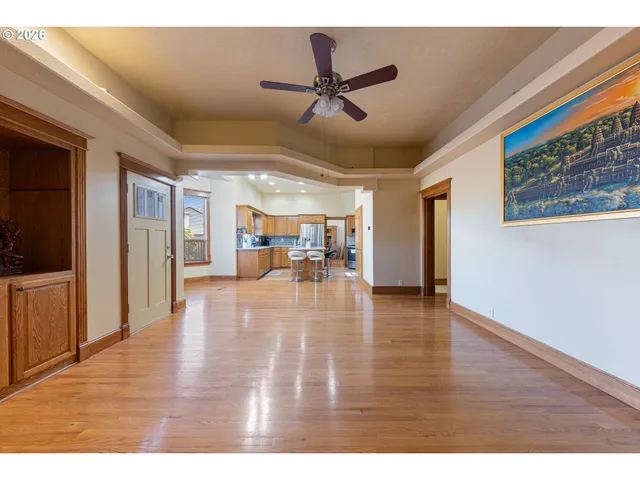 a view of a livingroom with hardwood floor and a ceiling fan
