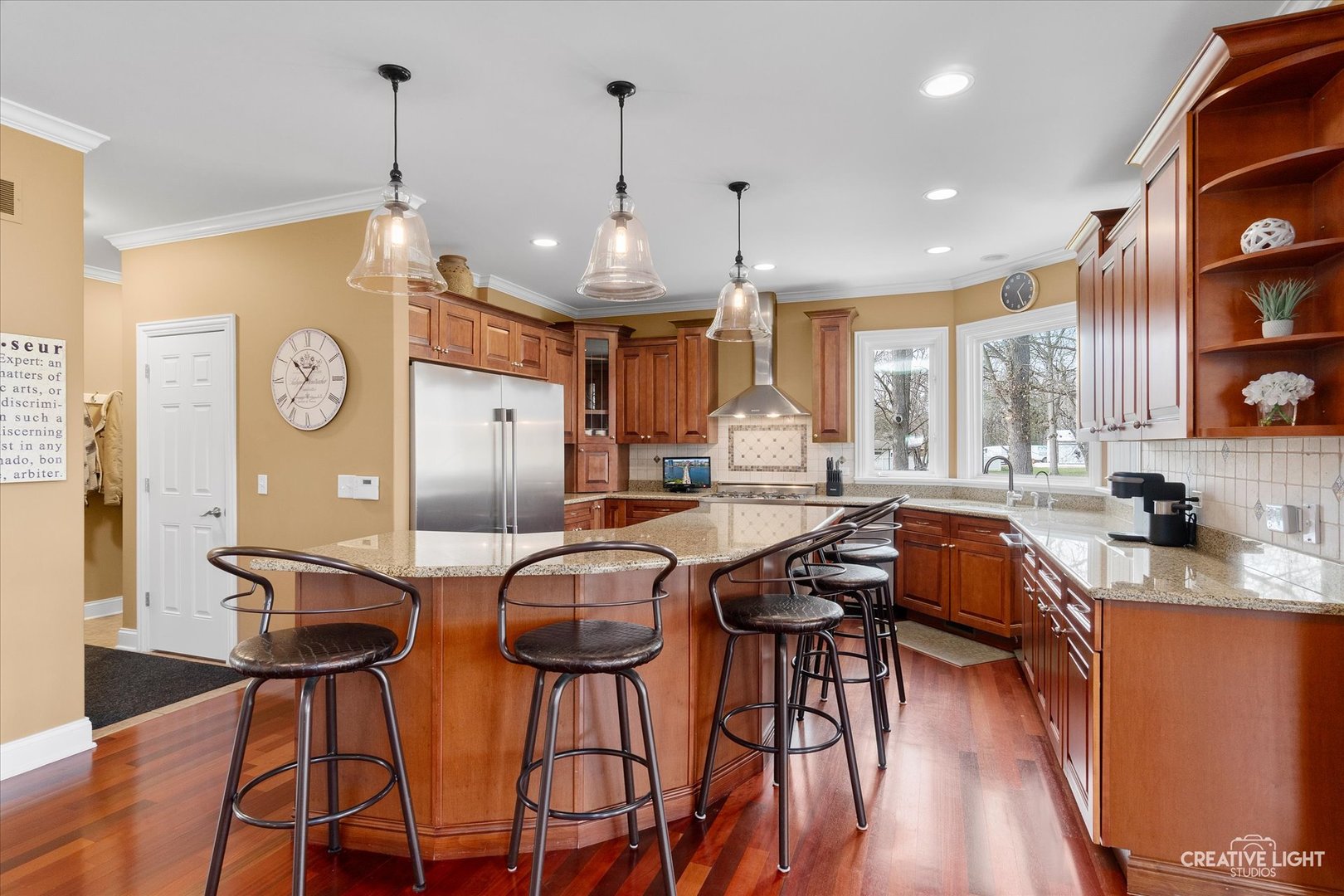 2086 Bilter Road Aurora, IL 60502 - Photo 13 of 59 a kitchen with stainless steel appliances granite countertop a stove a refrigerator a kitchen island with chairs and wooden floor