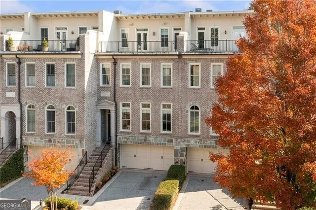 a view of a brick building next to a yard