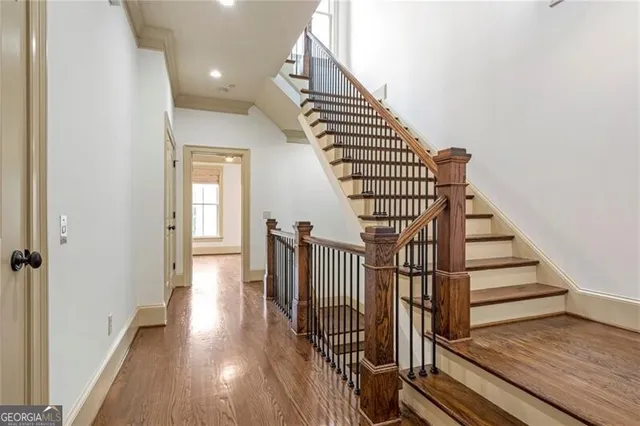 a view of entryway and hall with wooden floor