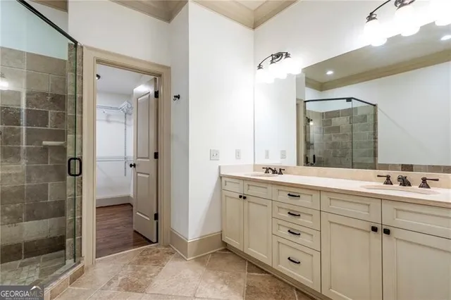 a bathroom with a double vanity sink mirror and shower