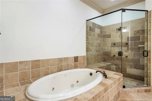 a bathroom with a bathtub and shower
