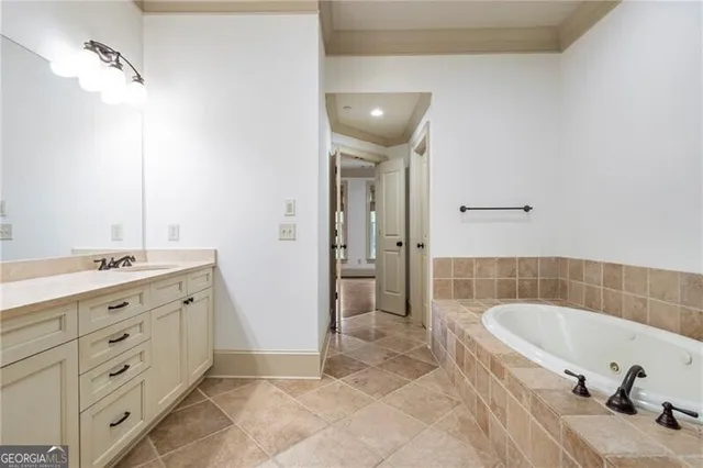 a bathroom with a tub sink and mirror