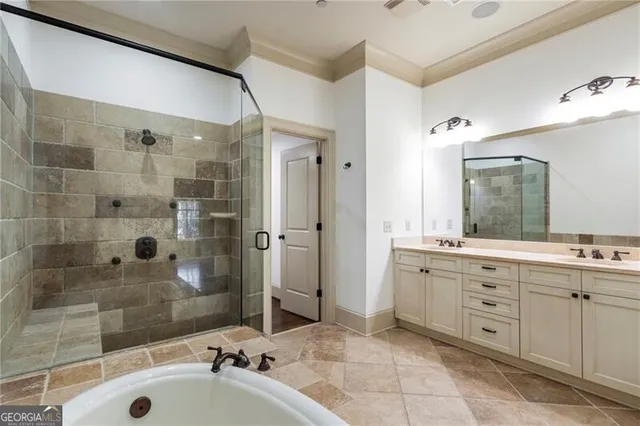 a bathroom with a tub sink shower and mirror