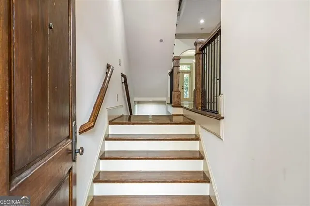 a view of staircase with white walls and a window