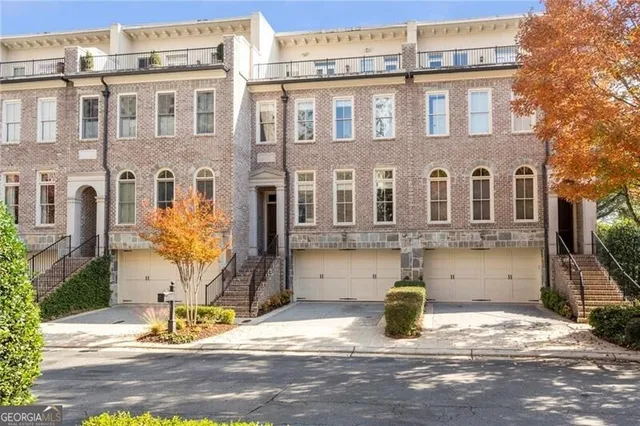 a view of a yard with large trees