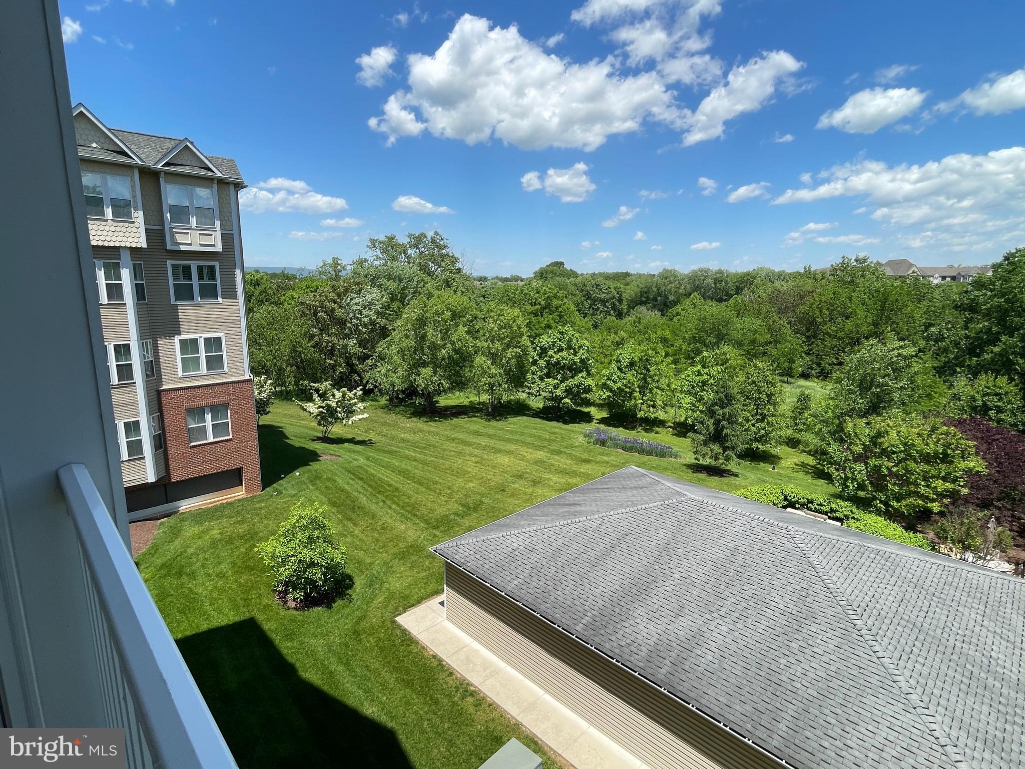 2250 Bear Den Road, Unit 308 Frederick, MD 21701 - Photo 23 of 71 a view of a garden with a building in the background