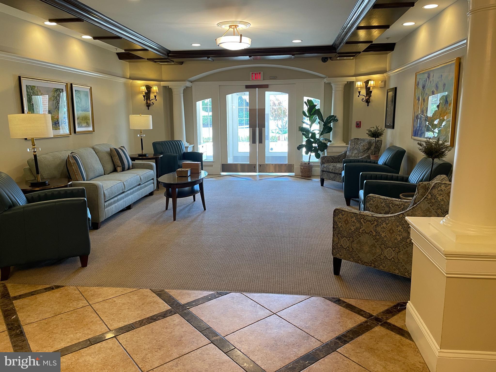 2250 Bear Den Road, Unit 308 Frederick, MD 21701 - Photo 5 of 71 a living room with furniture and a chandelier