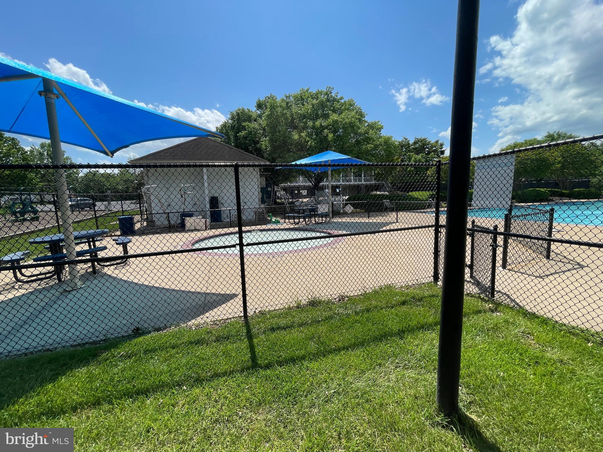 2250 Bear Den Road, Unit 308 Frederick, MD 21701 - Photo 65 of 71 a view of a patio with table and chairs under an umbrella