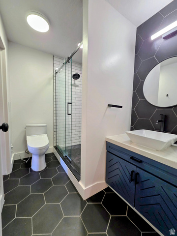 5265 South Rome Beauty Park Murray, UT 84123 - Photo 29 of 35 Full bath featuring dark tile patterned flooring, vanity, and a stall shower