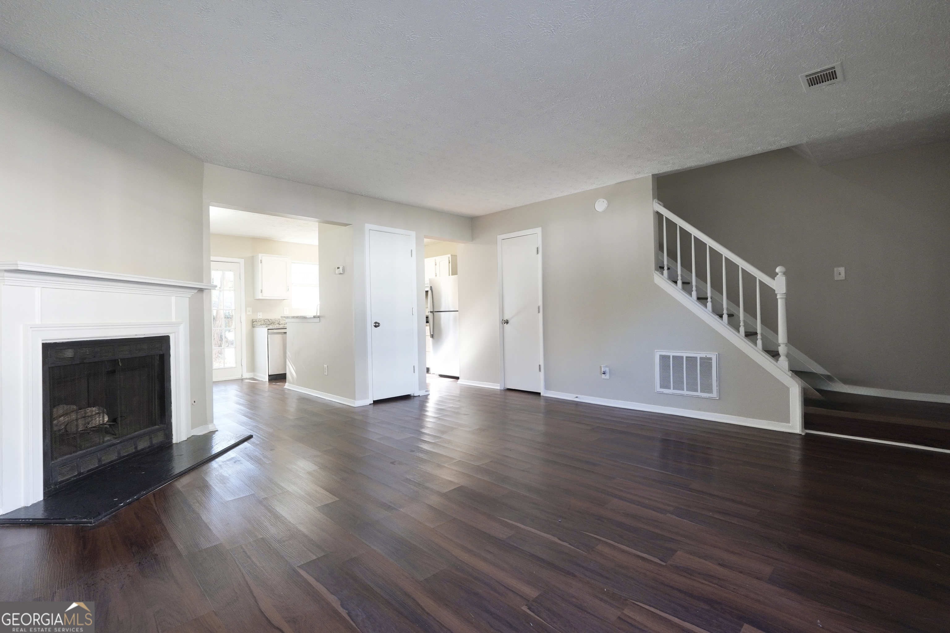 5702 Wells Circle Stone Mountain, GA 30087 - Photo 13 of 29 a view of a livingroom with wooden floor and a fireplace