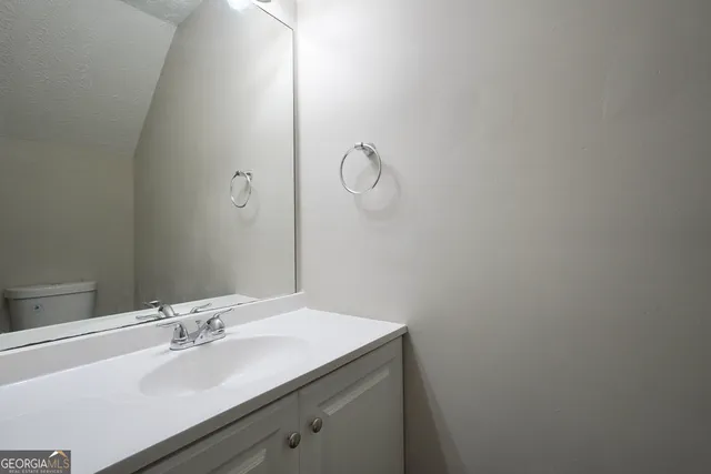 a bathroom with a sink and vanity