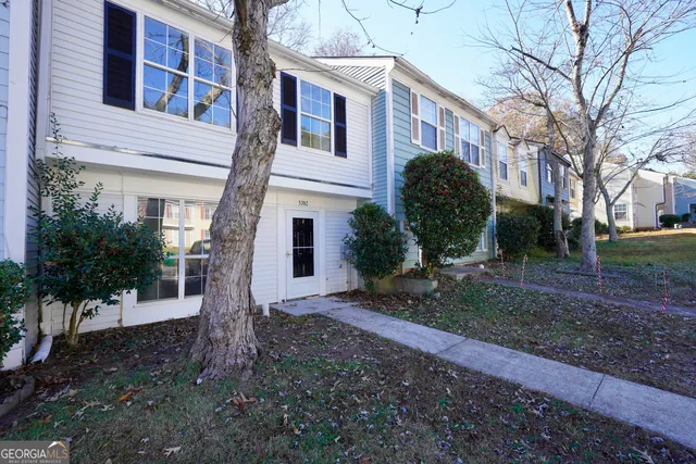 a view of a front of a house with a yard