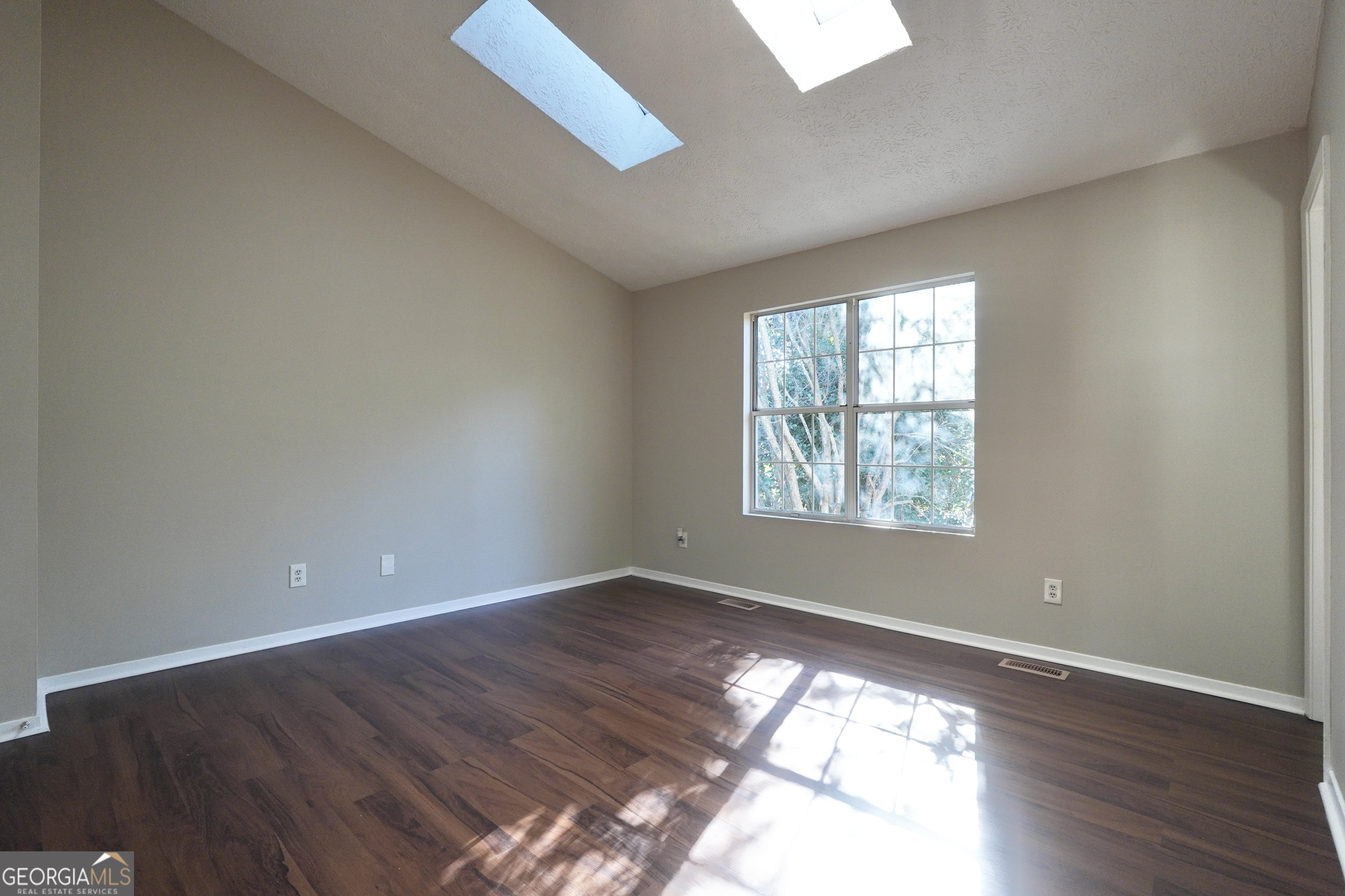 5702 Wells Circle Stone Mountain, GA 30087 - Photo 21 of 29 an empty room with wooden floor and windows