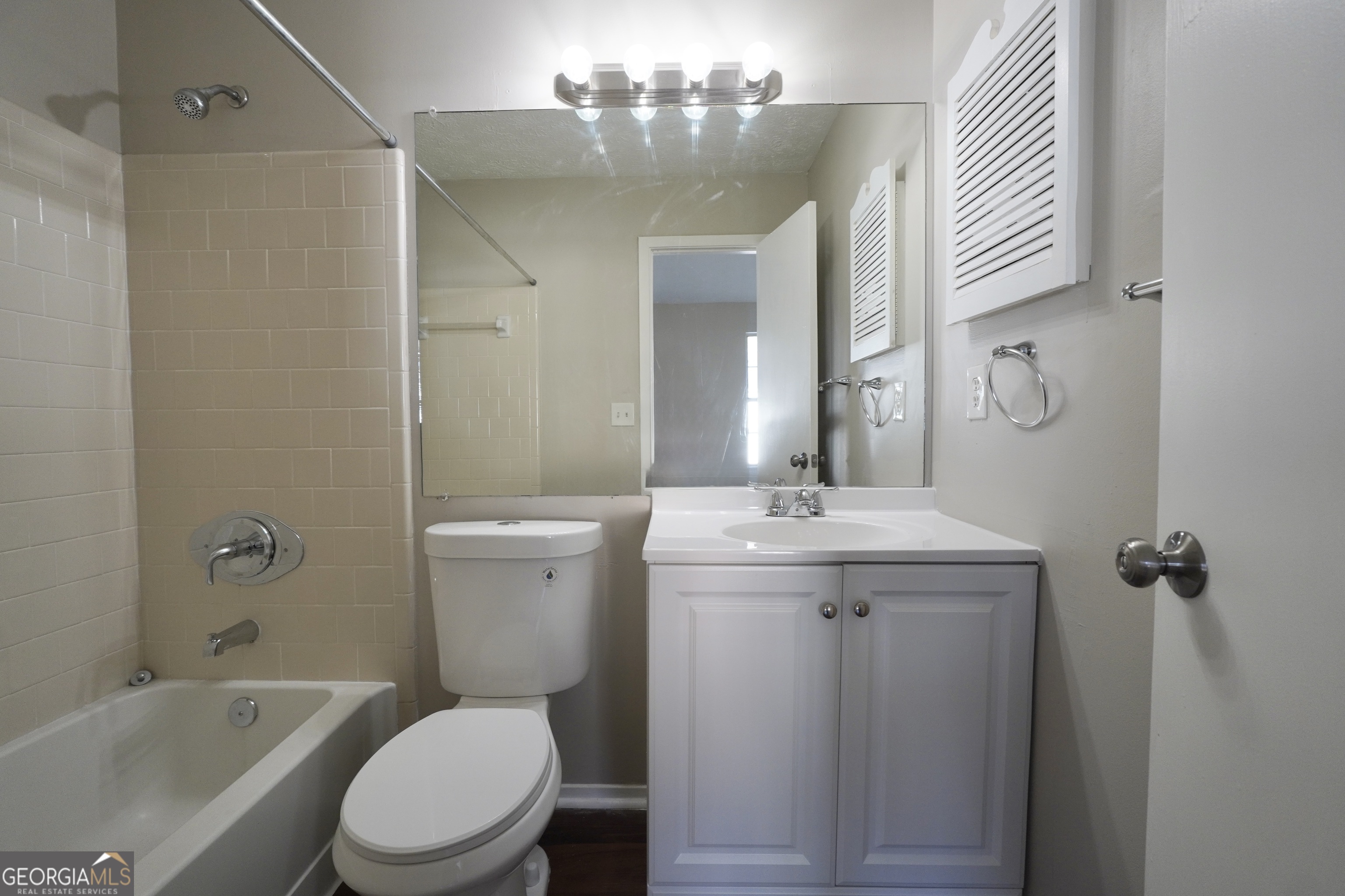 5702 Wells Circle Stone Mountain, GA 30087 - Photo 23 of 29 a bathroom with a toilet sink and mirror