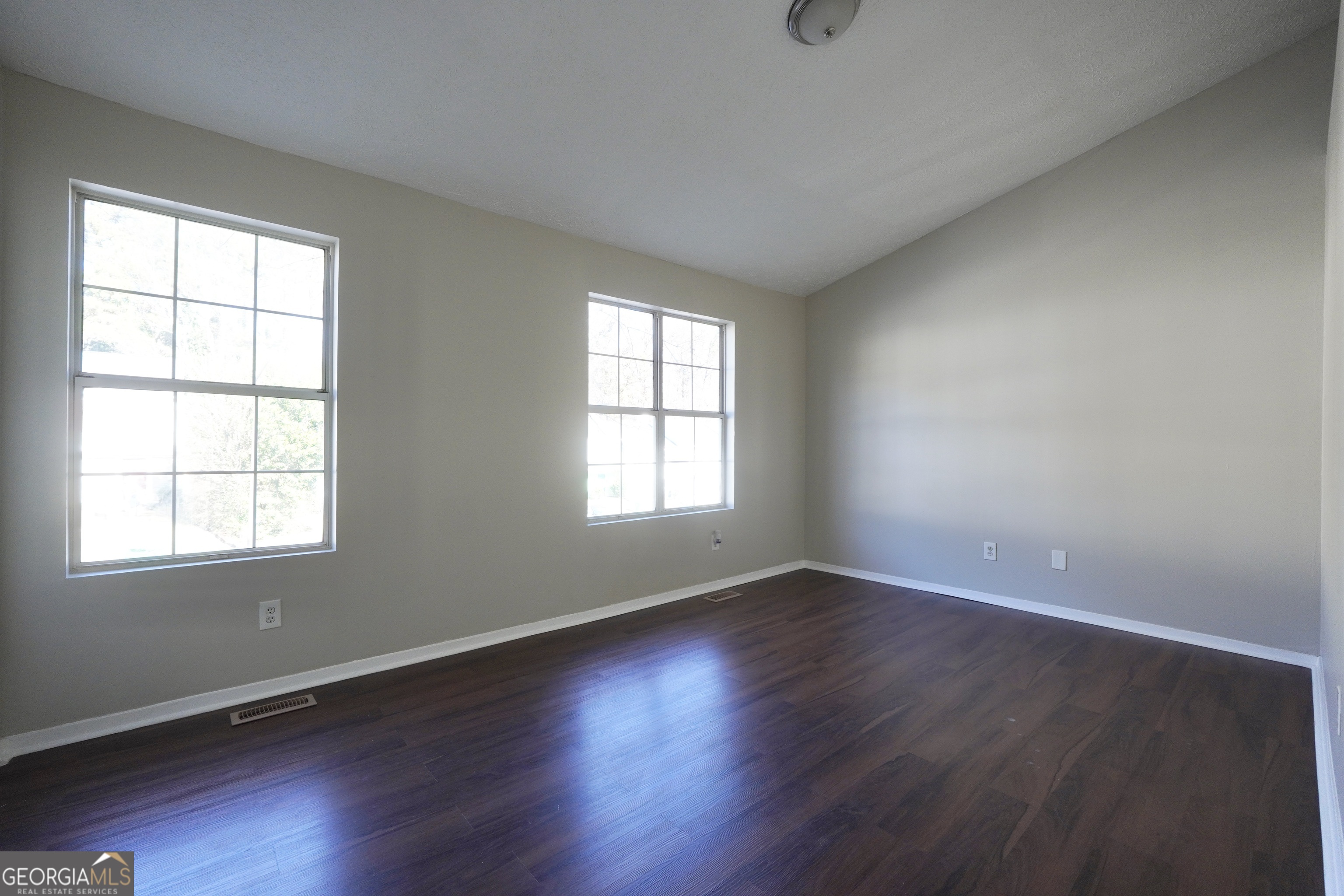 5702 Wells Circle Stone Mountain, GA 30087 - Photo 26 of 29 an empty room with wooden floor and windows