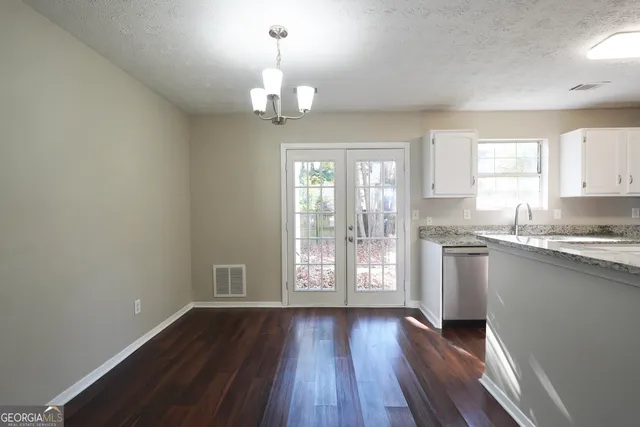 a view of kitchen with granite countertop stainless steel appliances sink and window