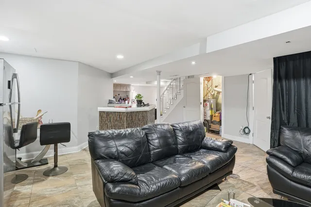a living room with furniture and a lamp