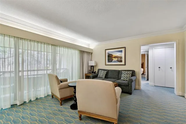 a view of a hallway with wooden floor and windows