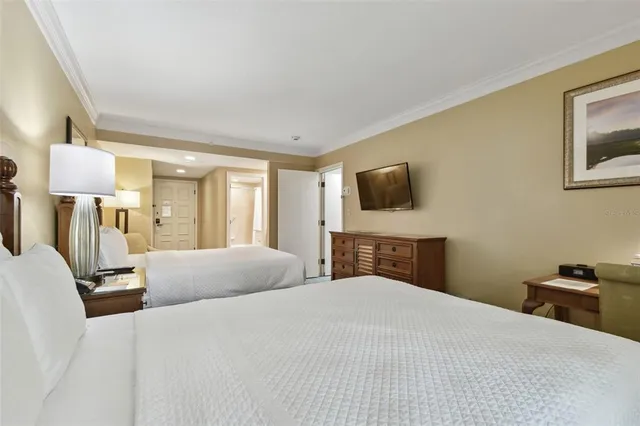 a view of a street with a building and palm tree