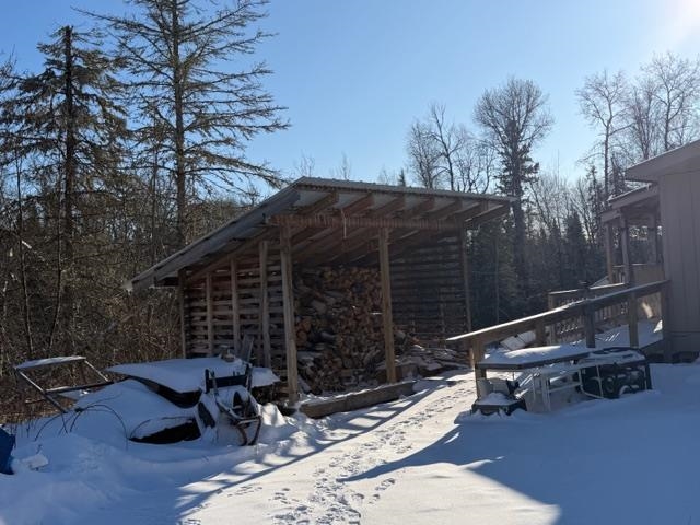 1152 Fernberg Road Ely, MN 55731 - Photo 15 of 24 Snowy yard with a wooden deck
