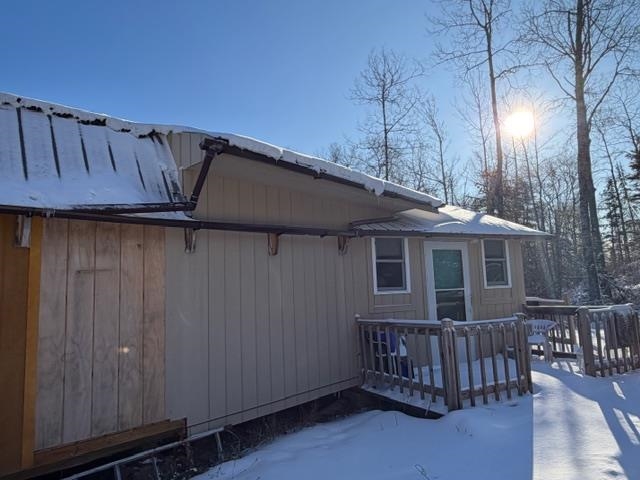 1152 Fernberg Road Ely, MN 55731 - Photo 22 of 24 Snow covered property featuring a wooden deck