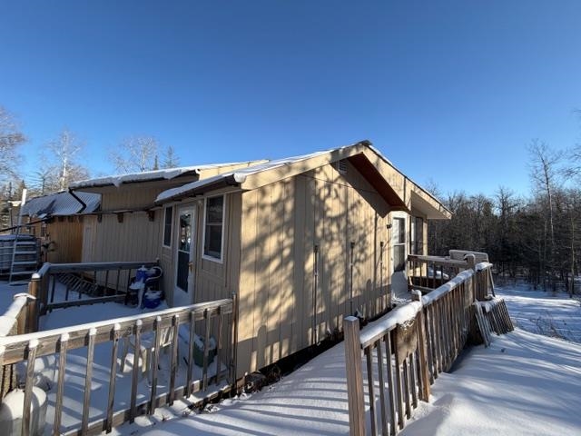 1152 Fernberg Road Ely, MN 55731 - Photo 23 of 24 View of snow covered exterior with a wooden deck