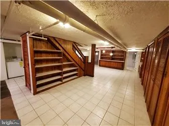 a room with walk in closet and wooden floor