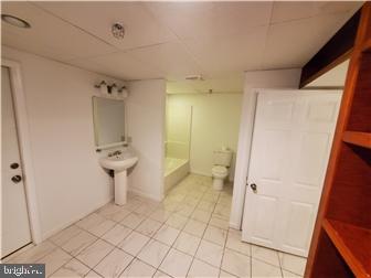 802 13th Street, Unit B New Castle, DE 19720 - Photo 15 of 17 a bathroom with a sink toilet and shower