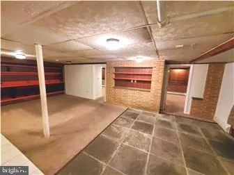 a view of a hall with wooden floor