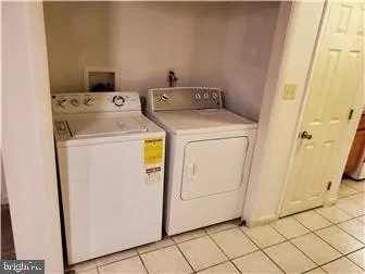 a large white kitchen with a stove a sink and a refrigerator